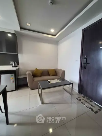 Modern living room with sleek furniture and minimalist design, featuring a cozy sofa and stylish coffee table.