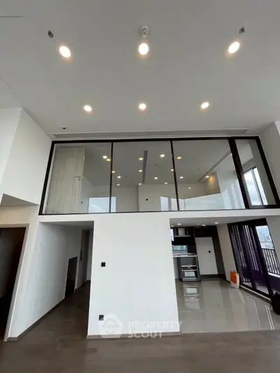 Spacious modern living room with high ceilings and large windows