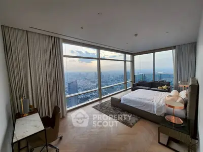 Luxurious bedroom with panoramic city view, featuring elegant decor and floor-to-ceiling windows.