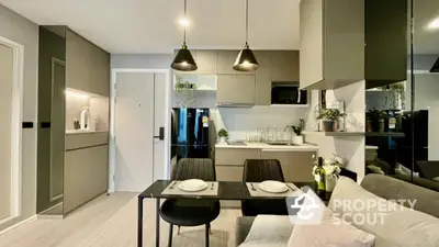 Modern kitchen and dining area with sleek cabinetry and stylish lighting