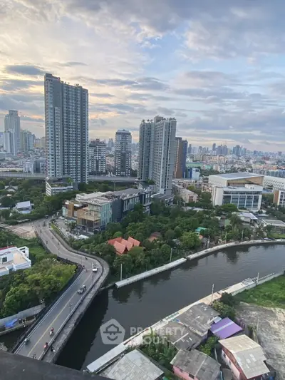 Stunning cityscape view from high-rise building overlooking urban skyline and river.