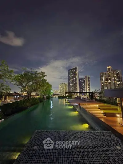 Luxurious rooftop pool with stunning city skyline view at night