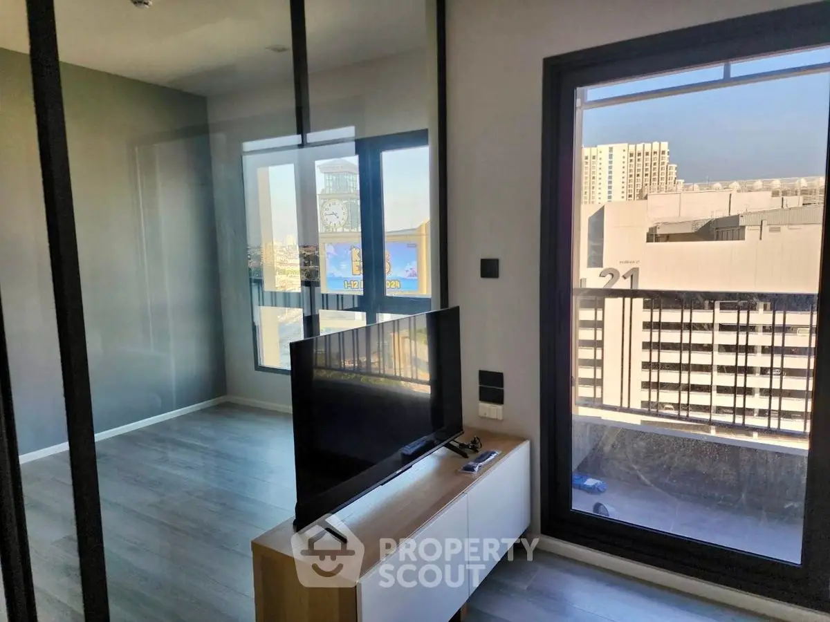 Modern living room with city view and sleek TV setup