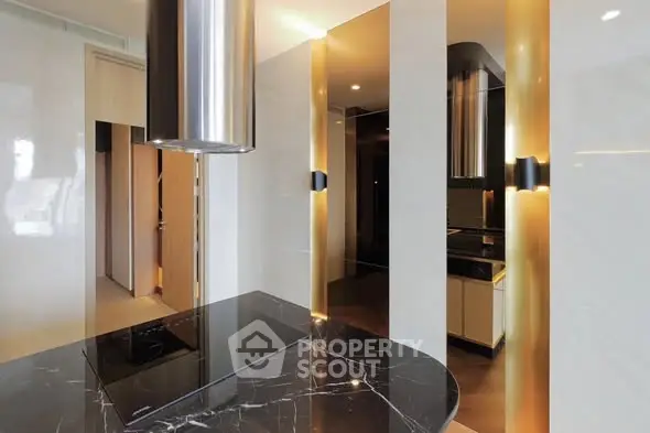 Luxurious modern kitchen with sleek black marble countertops and elegant lighting.