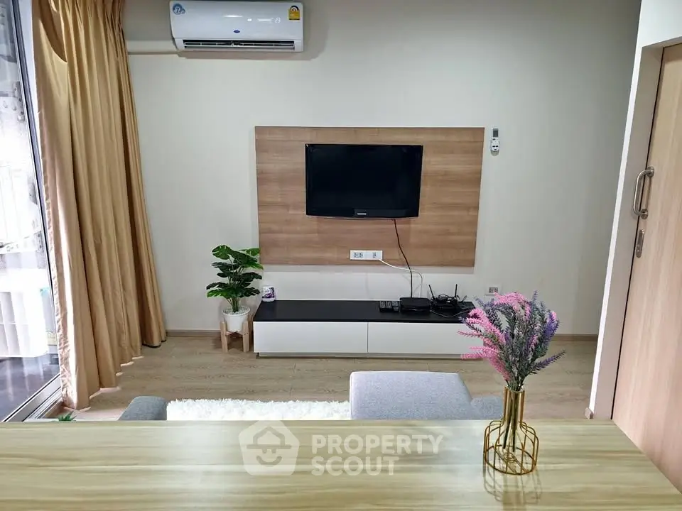Modern living room with wall-mounted TV and stylish decor