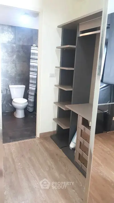 Modern apartment with sleek bathroom and built-in storage solutions.