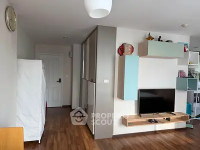 Modern living room with sleek furniture and wooden flooring in a stylish apartment.