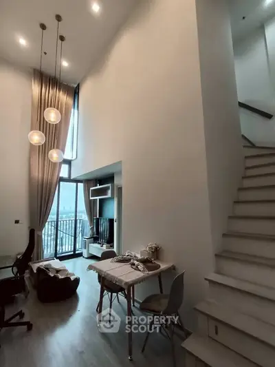 Modern duplex living room with high ceilings and stylish decor