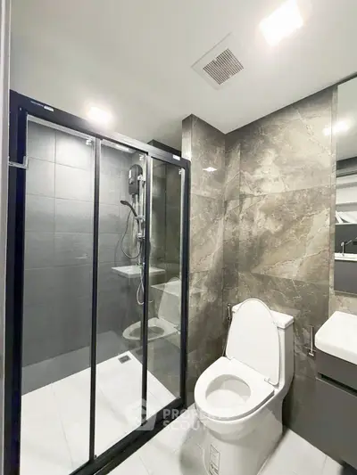 Modern bathroom with sleek shower and elegant marble tiles