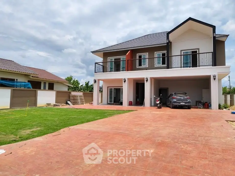 Stunning two-story house with spacious driveway and lush green lawn, perfect for family living.