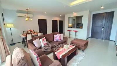 Spacious living room with modern decor and open layout in a stylish apartment.