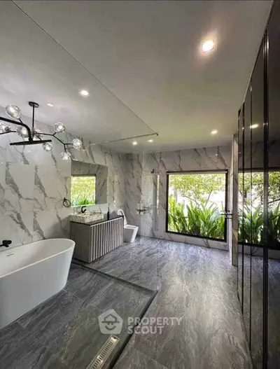 Luxurious modern bathroom with marble walls and freestanding bathtub