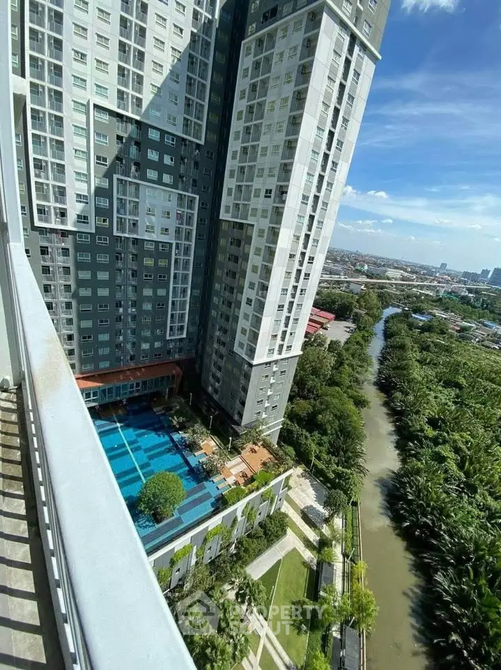 Stunning high-rise apartment with pool and river view, perfect for urban living.