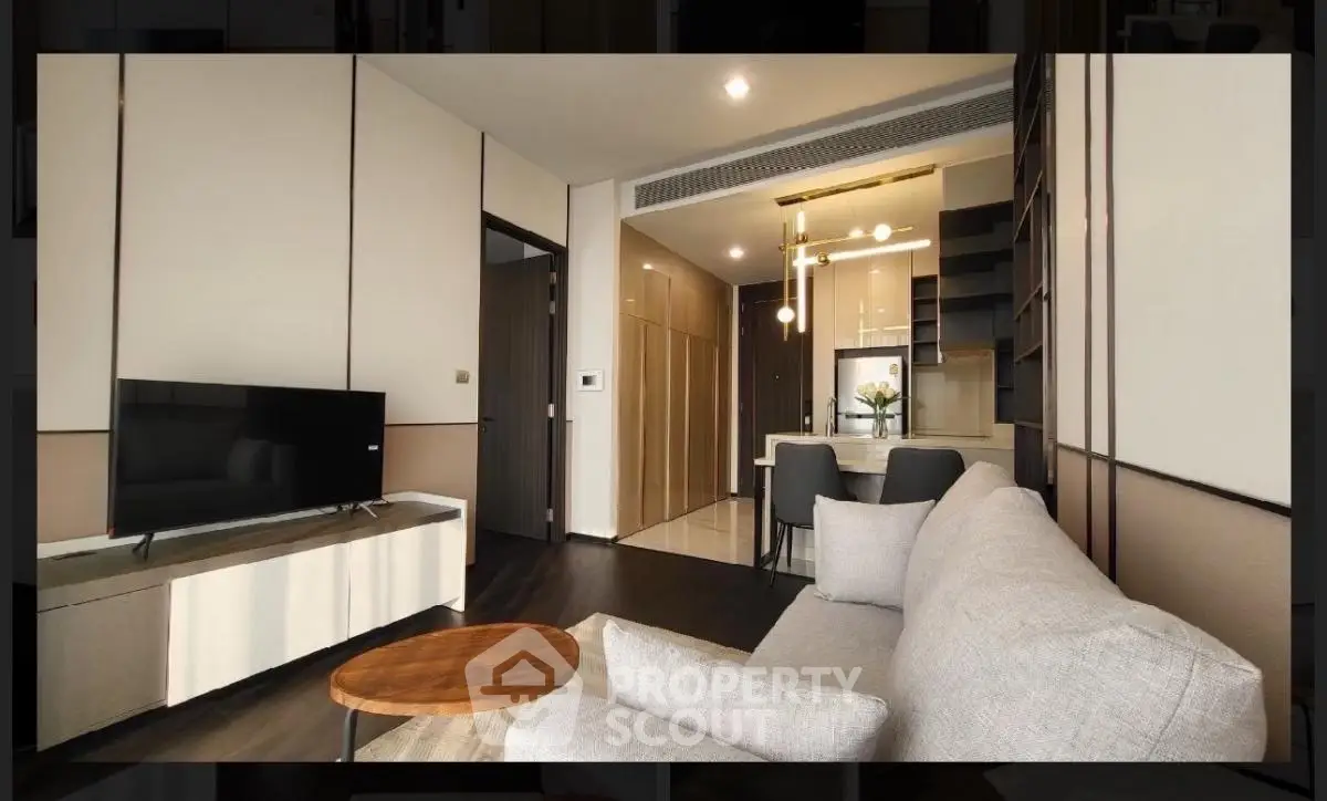 Modern living room with sleek furniture and open kitchen layout