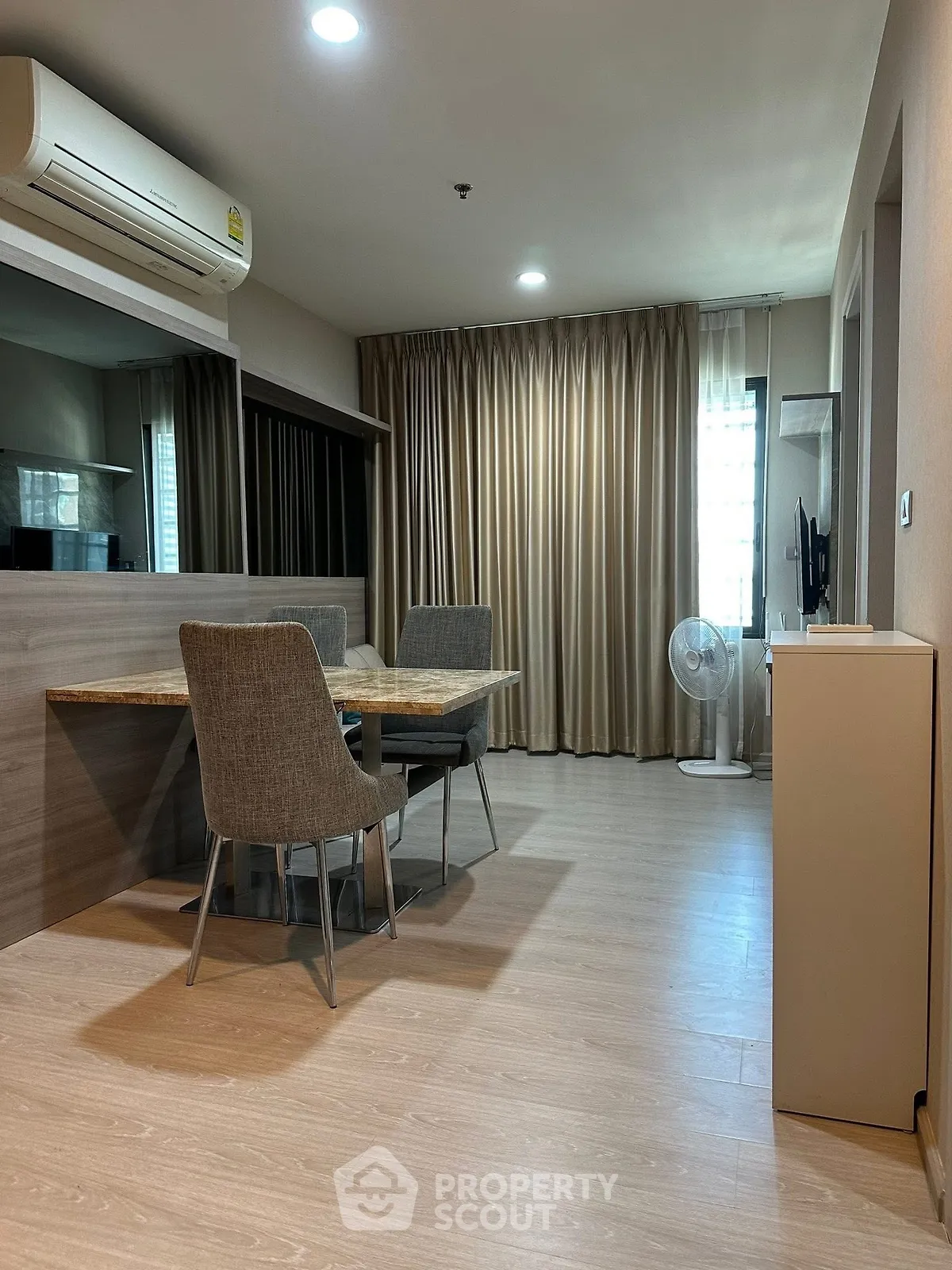 Modern living room with dining area and air conditioning in stylish apartment