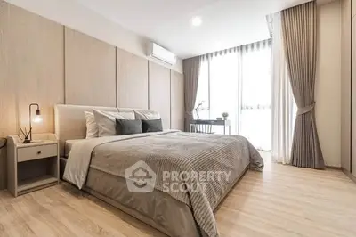 Spacious modern bedroom with elegant decor and natural light