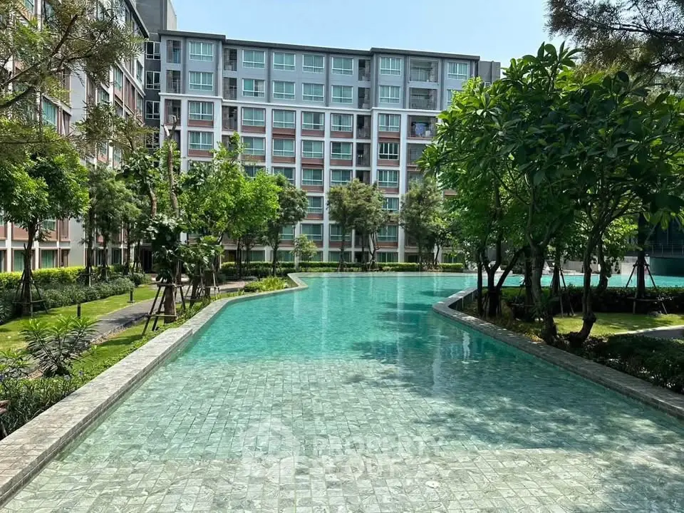Luxurious residential complex with a stunning pool and lush greenery, perfect for relaxation and leisure.