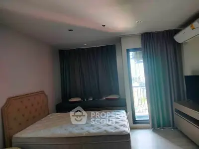Spacious bedroom with balcony access and modern furnishings