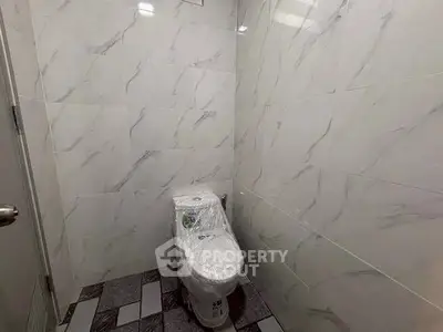 Modern bathroom with marble tiles and sleek toilet design