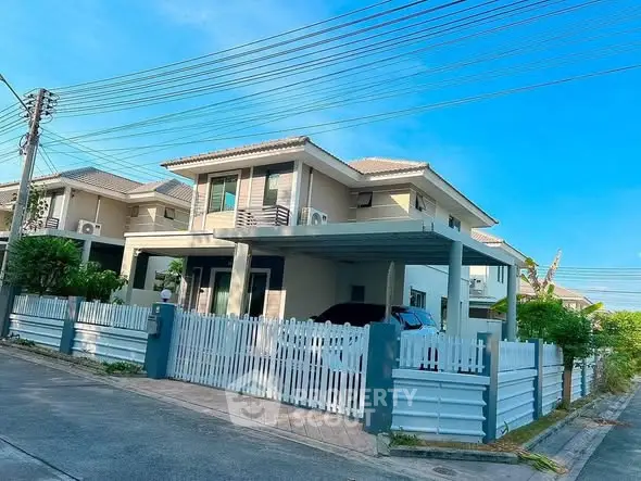 Charming two-story house with modern design and spacious driveway in a serene neighborhood.