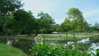 Serene garden view with lush greenery and tranquil pond, perfect for nature lovers seeking peaceful surroundings.