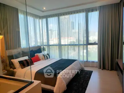 Luxurious bedroom with floor-to-ceiling windows offering stunning city views