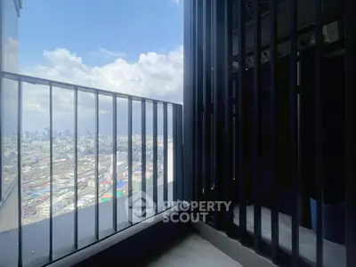 Stunning cityscape view from a modern high-rise balcony with sleek railing design.