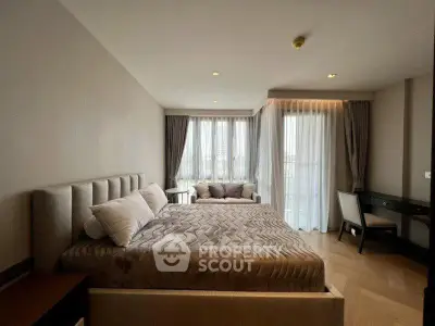Luxurious bedroom with elegant decor and large windows offering natural light.
