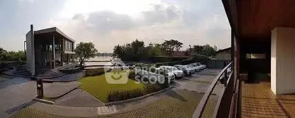 Stunning lakeside property with modern architecture and spacious parking area.