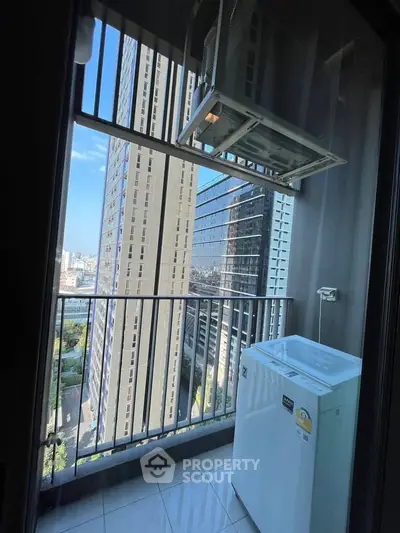 Modern high-rise balcony with washing machine and city view, perfect for urban living.
