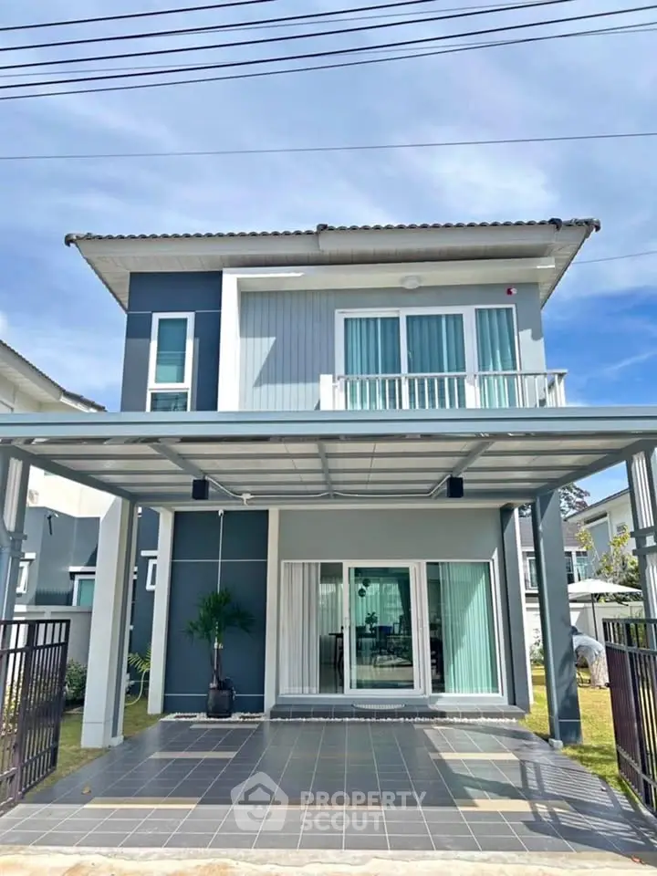 Modern two-story house with sleek design and spacious carport in a suburban neighborhood.