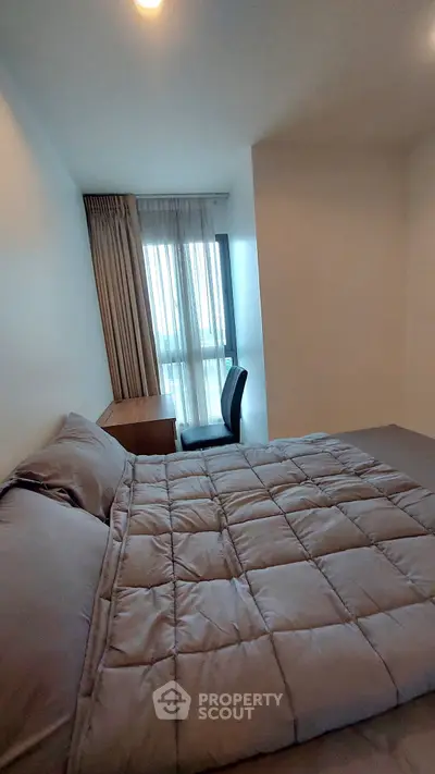 Cozy bedroom with modern decor and natural light, perfect for relaxation and comfort.