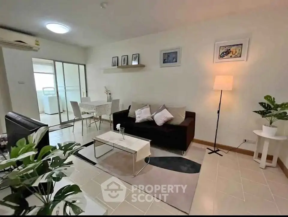Modern living room with stylish decor and open dining area, perfect for cozy gatherings.