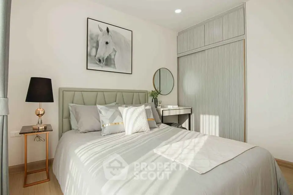 Modern bedroom with stylish decor and ample natural light, featuring a cozy bed and elegant furnishings.