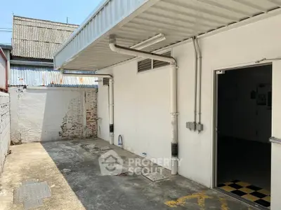 Spacious outdoor area with covered roof and open entrance, ideal for versatile use.