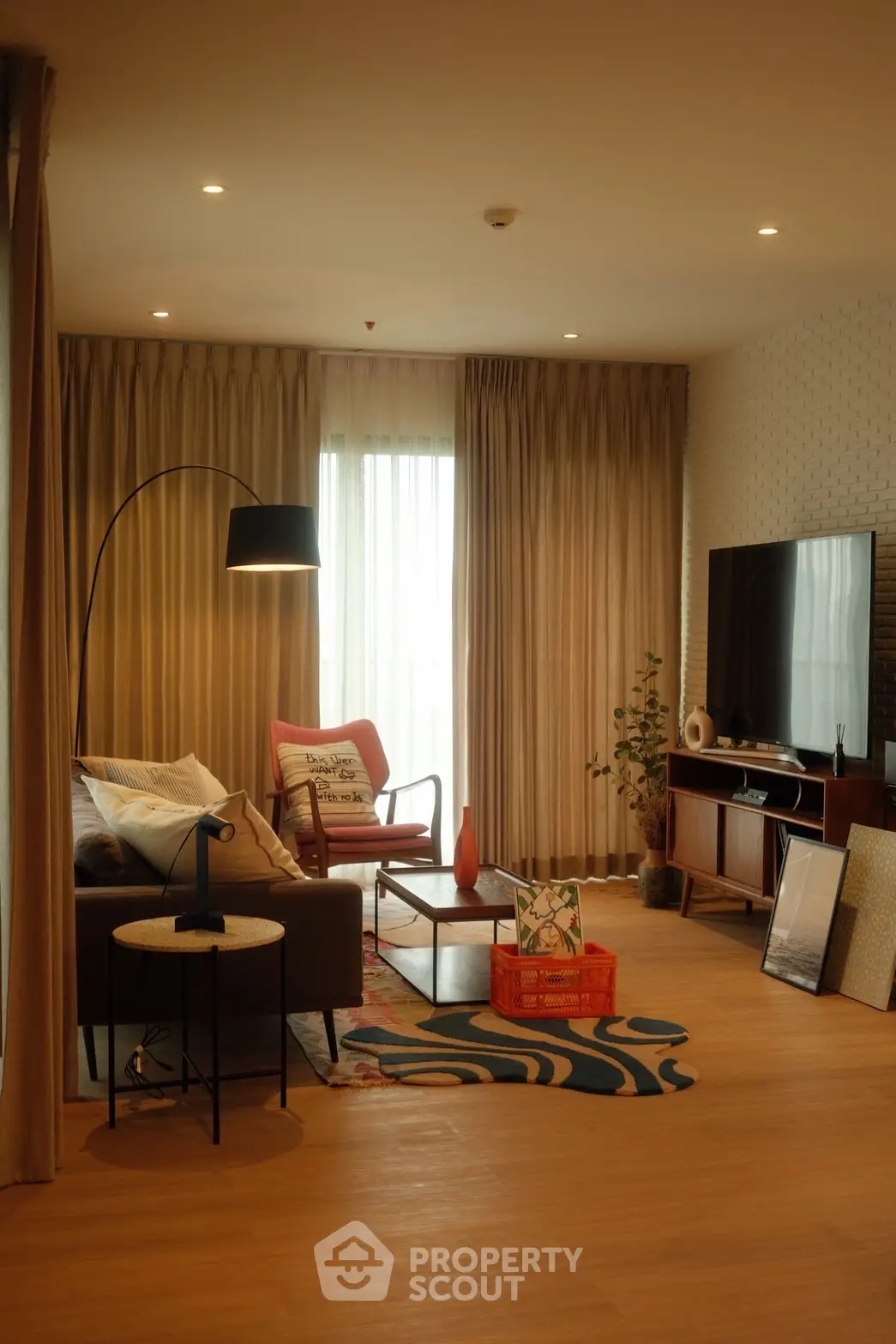 Stylish living room with modern decor, cozy seating, and ambient lighting for a warm atmosphere.