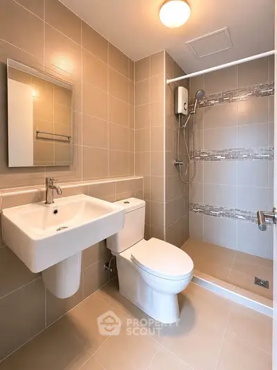Modern bathroom with sleek fixtures and walk-in shower in a contemporary apartment.