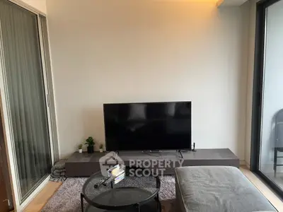 Modern living room with sleek TV setup and cozy seating area