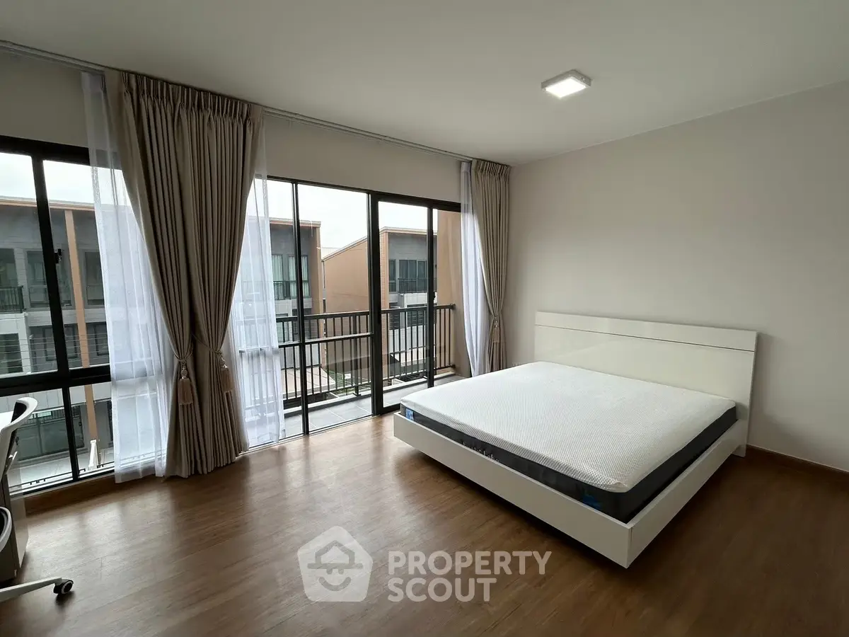 Spacious bedroom with large windows and modern decor in a stylish apartment