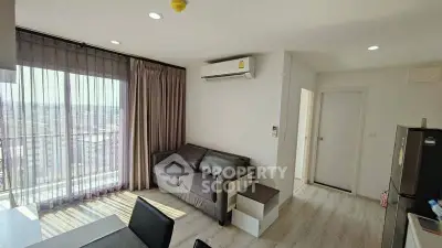 Modern living room with large window and air conditioning in a high-rise apartment