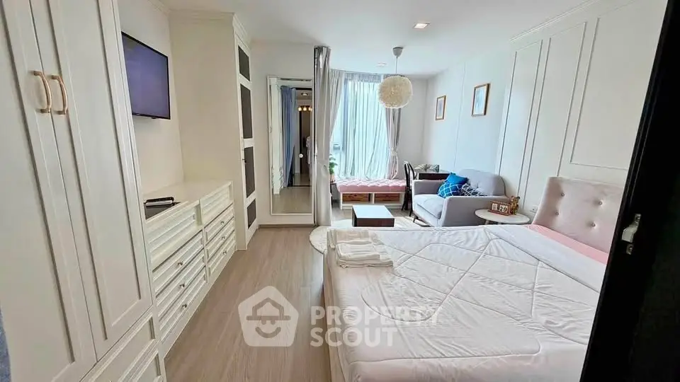 Spacious bedroom with elegant decor and natural light in modern apartment