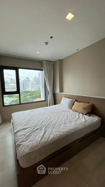 Spacious bedroom with city view in modern apartment