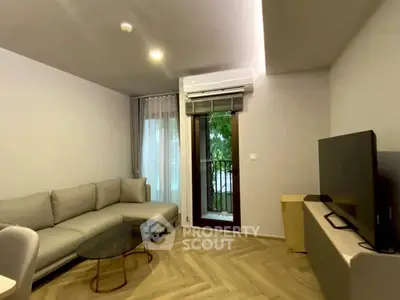 Modern living room with sleek furniture and balcony access