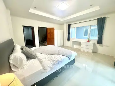 Spacious modern bedroom with elegant decor and natural light
