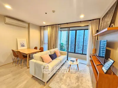 Spacious modern living room with city view, cozy seating, and elegant decor.