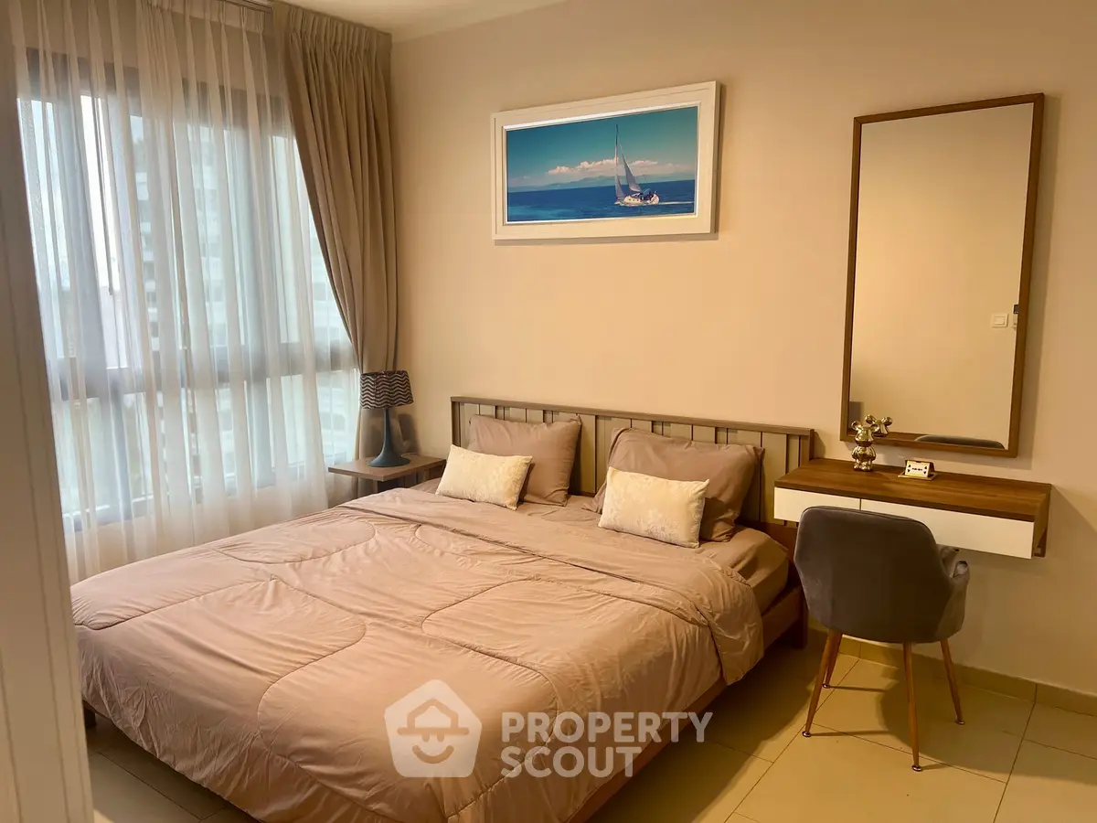Cozy bedroom with modern decor and natural light in a stylish apartment.