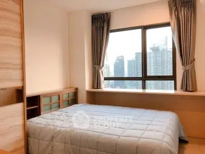 Modern bedroom with city view, featuring large window and stylish decor.