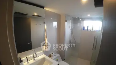 Modern bathroom with glass shower and sleek fixtures