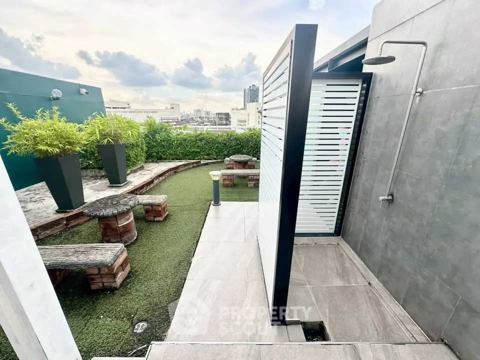 Stunning rooftop terrace with outdoor shower and city views, perfect for relaxation and entertaining.