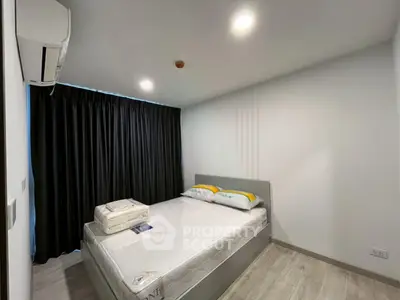Modern bedroom with cozy lighting and stylish decor in a contemporary apartment.